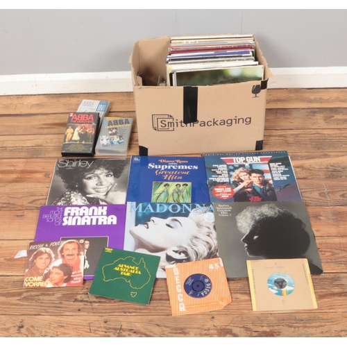 180 - A box of assorted vinyl records and singles of mainly pop and easy listening to include Madonna, Abb... 