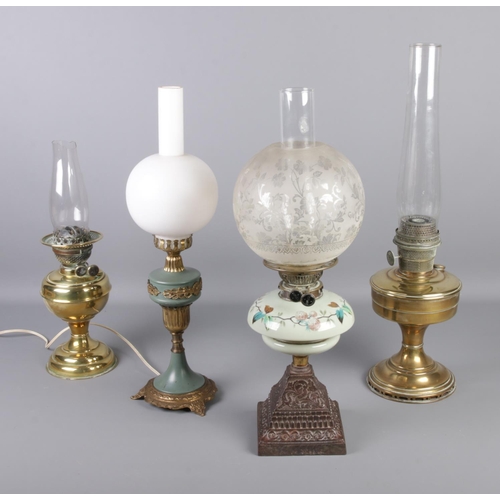 40 - Four oil lamps with glass shades, one converted to electric with other duplex examples.
