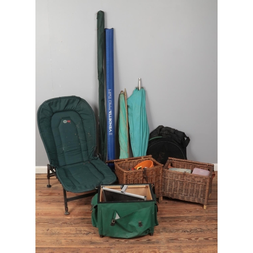 189 - A collection of assorted fishing equipment including Catch Carp adjustable chair, nets, wicker baske... 