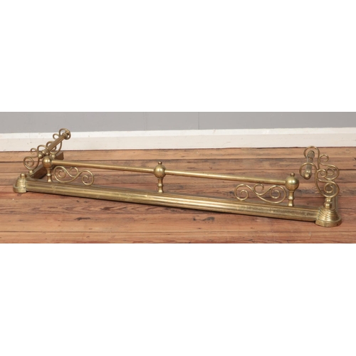 193 - A brass non-extending fire fender featuring scroll and bar details. Approx. dimensions 134cm x 38cm