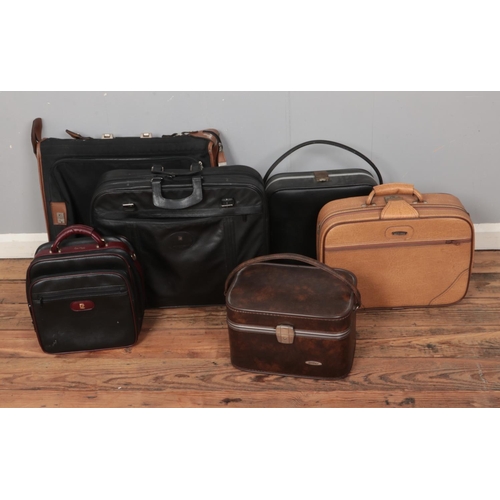 195 - A collection of vintage suitcases and carry cases including black leather example stamped Givenchy t... 