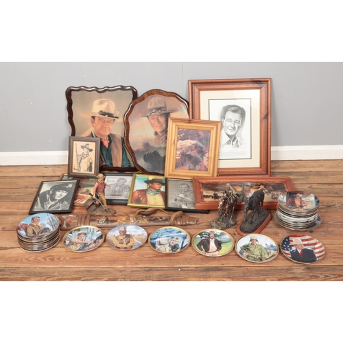 209 - A large collection of John Wayne memorabilia to including assorted pictures, cabinet plates, rifle d... 