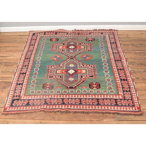 211 - A Tariq Sulton & Company wool rug featuring variegated green background. Made in Pakistan. Approx. d... 