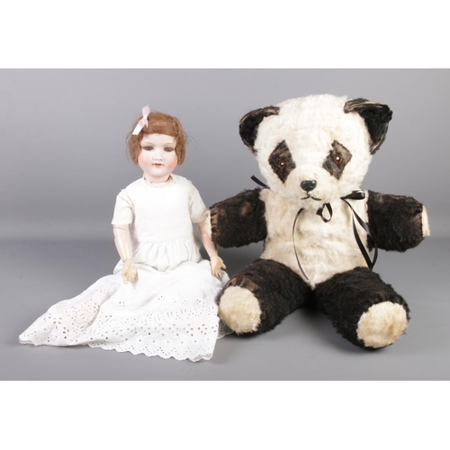 216 - A large plush Giant Panda, together with an Armand Marseille mould 390 7½M doll. Stamped Germany 390... 