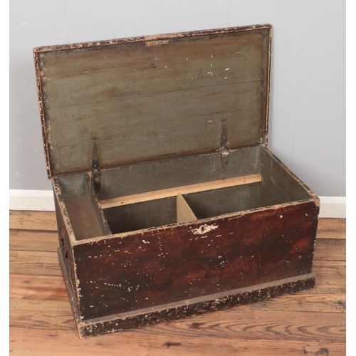 219 - A small painted blanket box with semi fitted interior.