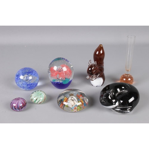 60 - A collection of glassware to include several paperweights and bubble bud vase.