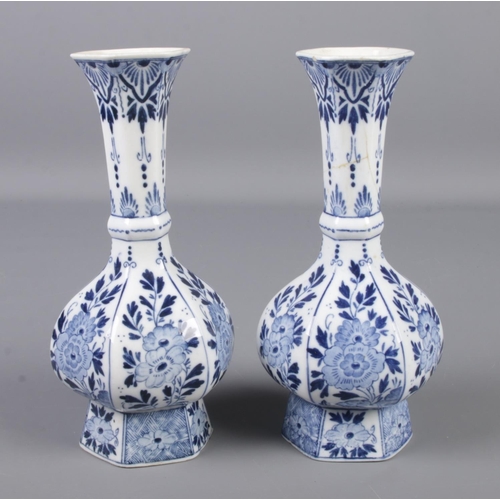 67 - A pair of blue and white Delft vases. Height 21cm.