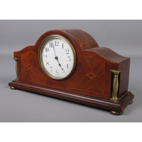 70 - An Edwardian inlaid mahogany mantel clock. Having French movement.