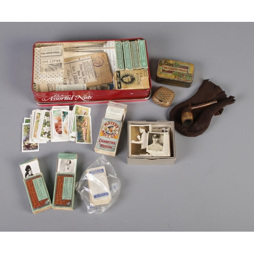 72 - A tin of assorted cigarette and tea cards, miniature pipe, snuff box and tobacco tin. To include Wil... 