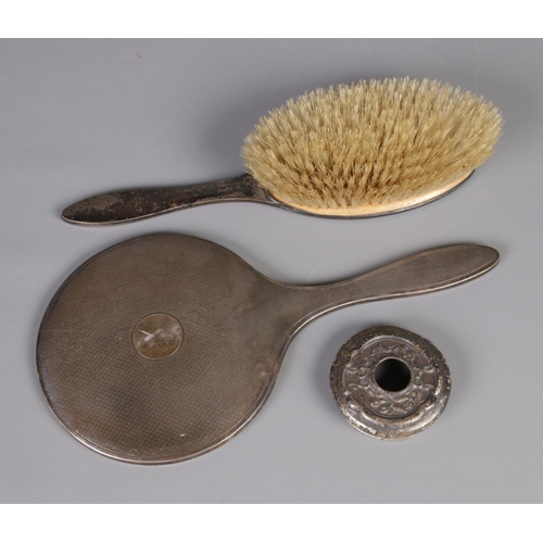 393 - A silver handled vanity mirror and brush along with silver lid.  Hallmarks various.