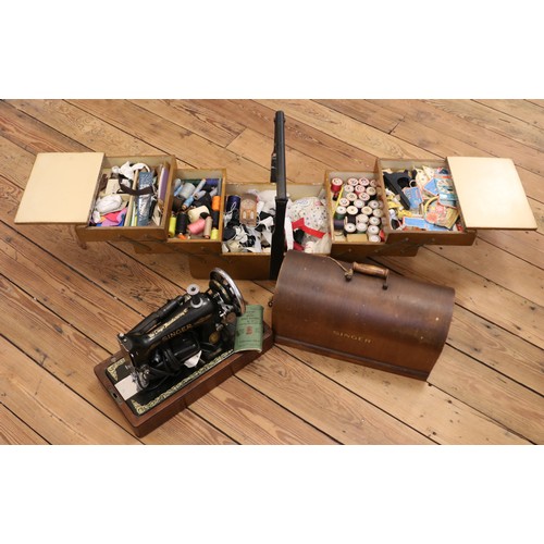 198 - A cased Singer sewing machine, together with a cantilever sewing box and contents.