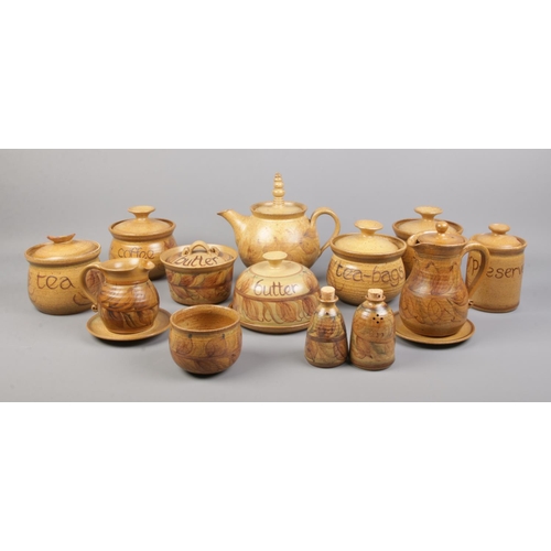 54 - A collection of Alvingham studio pottery, to include tea pot, lidded sugar bowl, butter dish and cov... 