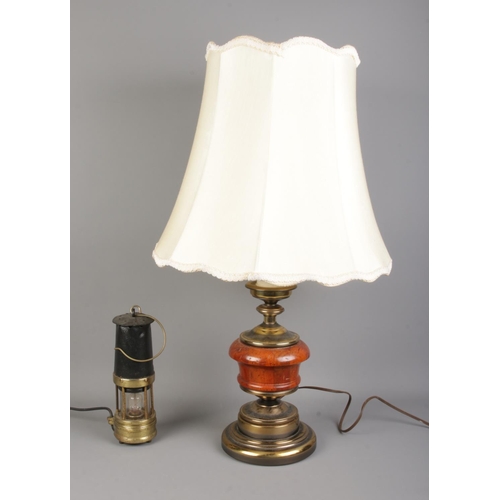 52 - A brass and wooden bodied table light, together with a miners lamp; which has been converted to elec... 
