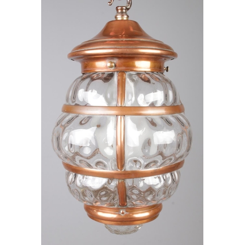 275 - A hanging copper mounted lantern with bubble effect glass panels. With wall mounted hook fixture. He... 
