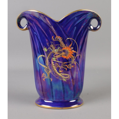 10 - A Crown Devon blue lustre vase depicting oriental style dragon. 17.5cm tall.