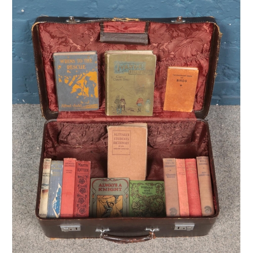 473 - A vintage suitcase containing an assortment of antique and vintage books. To include 'Ivanda A Tale ... 