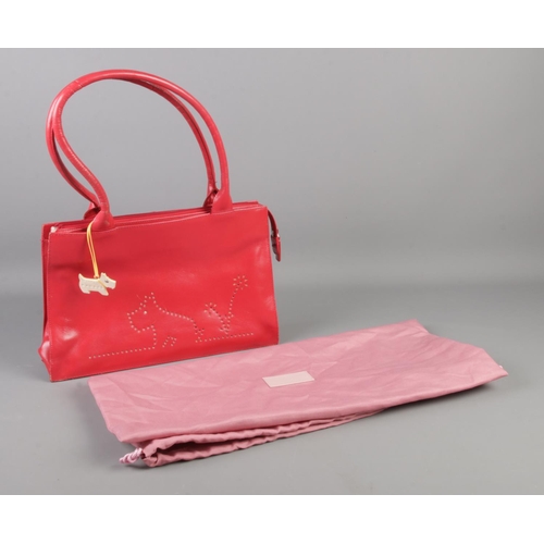 116 - A red Radley handbag, with pink dust bag.