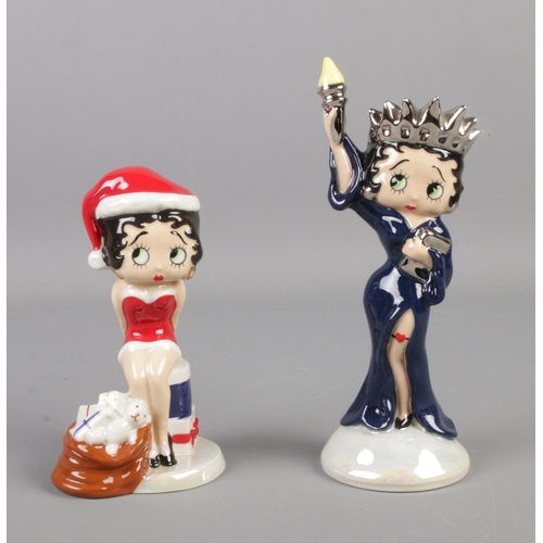 124 - Two Wade ceramic Betty Boop figures; 'Christmas Surprise' and 'Liberty'. Tallest: 18cm.