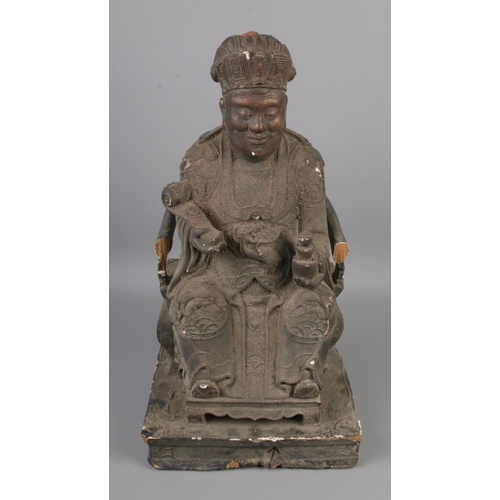 142 - A Chinese carved wooden figure of an emperor/official