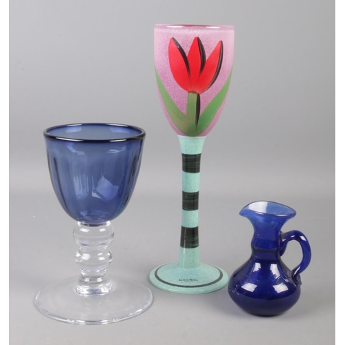 145 - A Kosta Boda drinking glass handpainted with tulips by Ulrica Hydman Vallien along with two blown gl... 