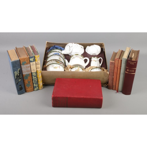 147 - An early 20th century boxed childs/dolls tea set along with a collection of books.