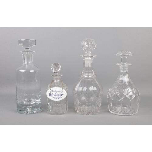 153 - Four glass decanters, with smallest example bearing enameled label for 'Medicinal Brandy'. Tallest: ... 