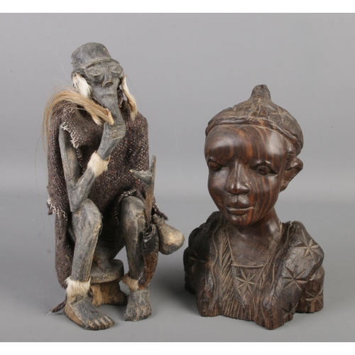 157 - Two African wooden tribal carvings. One of a seated figure, the other a bust. Height of seated figur... 