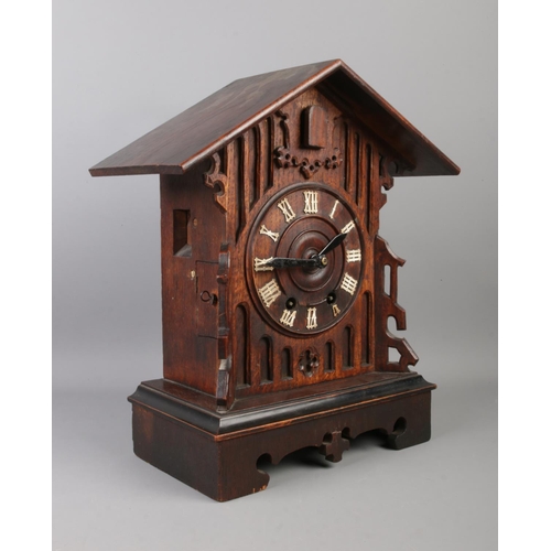 21 - A Black Forest cuckoo clock, with roman numeral dial, chiming on a coiled gong. Movement stamped for... 