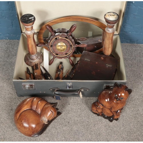 185 - A Globetrotter suitcase with contents of assorted woodenware. Including large candlesticks, cat figu... 