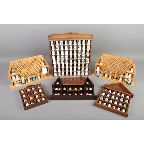 198 - A quantity of thimbles on display stands. Includes examples formed as a house, etc.