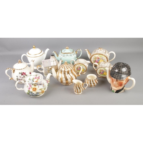 207 - A large collection of mostly Sadler teapot collectables with other examples by different makers inlc... 