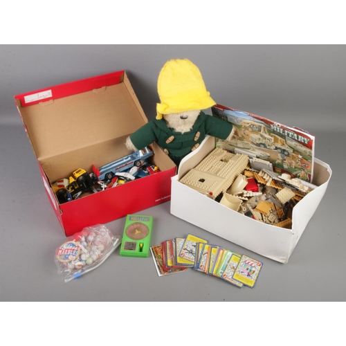 210 - A box of assorted toys. Includes diecast vehicles, Paddington bear, Oxford military building set etc... 