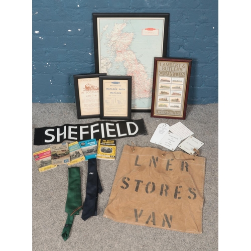 214 - A box of railwayana. Includes Lambert & Butler's cigarette cards, framed map, booklets, etc.