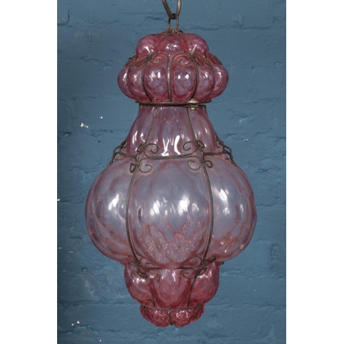259 - A pink blown glass and wirework hanging light.