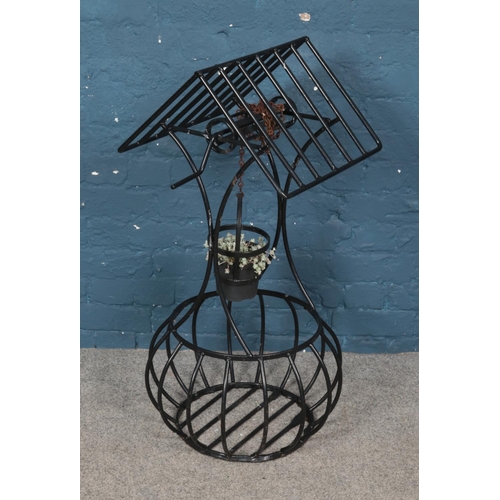 279 - A painted metal planted formed as a well. (95cm)