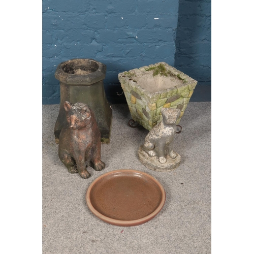 282 - A quantity of concrete garden ornaments. Including cat & dog figure, etc.