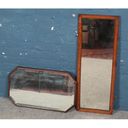 296 - Two oak framed mirrors. Includes carved octagonal bevel edge example, etc.