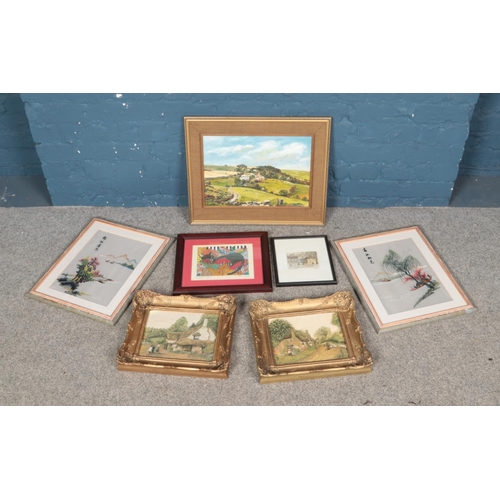 297 - A collecting of artwork including etchings depicting a cat and a street view, an oil on board landsc... 