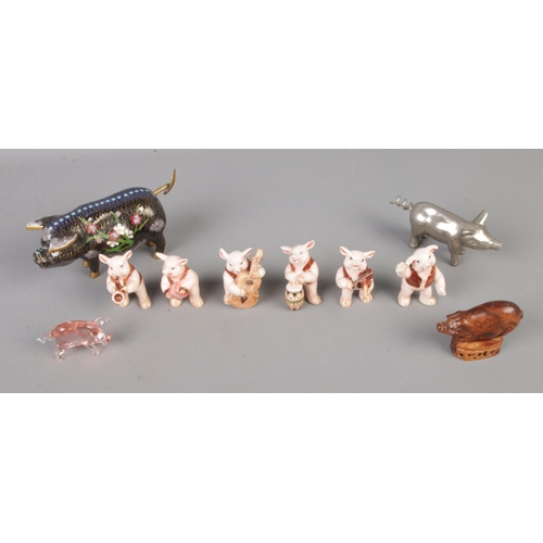 63 - A collection of assorted pig figures including novelty corkscrew, art glass and ceramic musicians ex... 