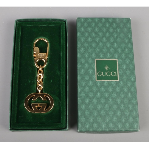 329 - A boxed Gucci gold tone keyring in box. Stamped 'Gucci' and 'Made in Italy'