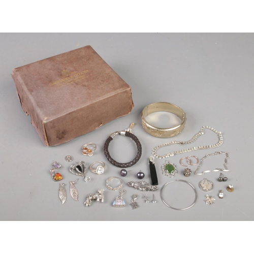 334 - A Garrard & Co box with contents of silver and white metal jewellery. Includes bangle (40.52g), Thom... 