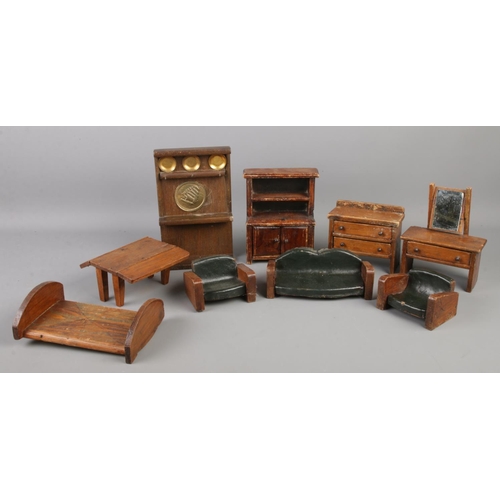 68 - A collection of early Twentieth century wooden dolls house furniture. Includes dresser, drop leaf ta... 