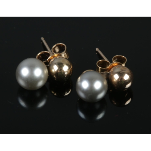 342 - A pair of 9ct gold and grey pearl earrings.