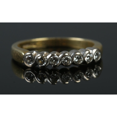 344 - An 18ct gold and seven stone diamond ring. Sponsor mark for Fred E Ullman. Size O. 4.24g.