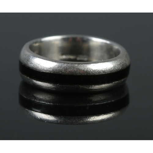 348 - A platinum ring with jet inset band. Size N 1/2. 12.96g.