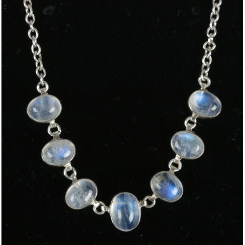 351 - A silver necklet set with seven cabochon moonstones. Tested.