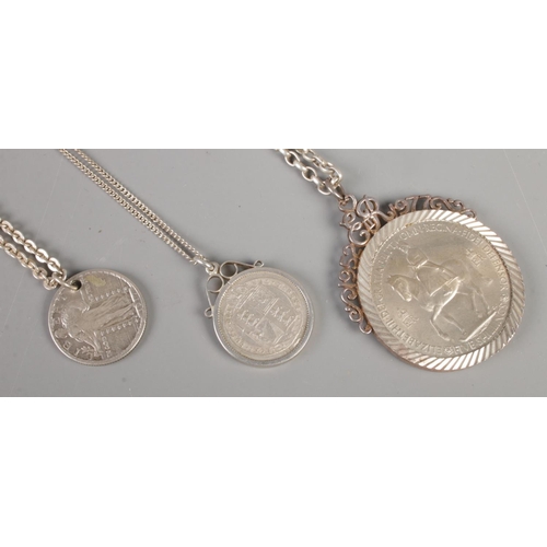 354 - Three coins on silver chains. Comprising of 1887 shilling, 1917 quarter dollar and 1953 five shillin... 