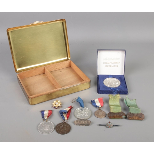 71 - A brass state express box with contents of assorted badges, medallions and metals. To include Sheffi... 