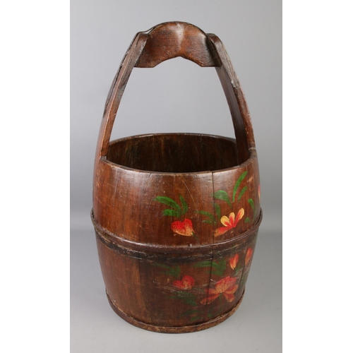 76 - A vintage wooden well bucket with metal mounts.