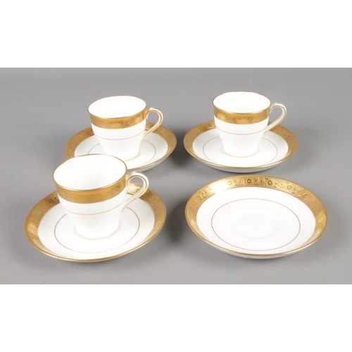 379 - A collection of Davis Collamore & Co for Minton tea cups and saucers featuring gilt decoration. Incl... 